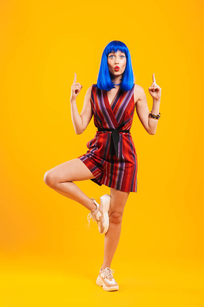 Portrait of an attractive funky young girl with blue hair - 写真・画像
