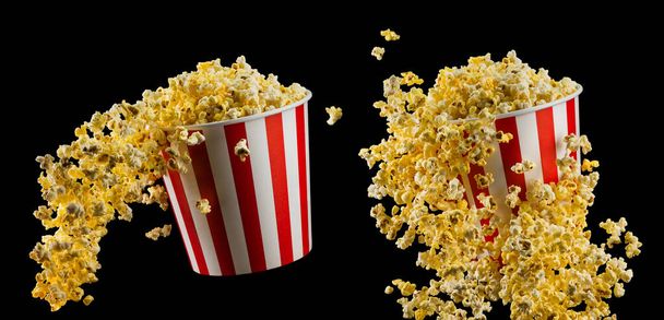 Set of paper striped buckets with popcorn isolated on black background - Foto, Imagem