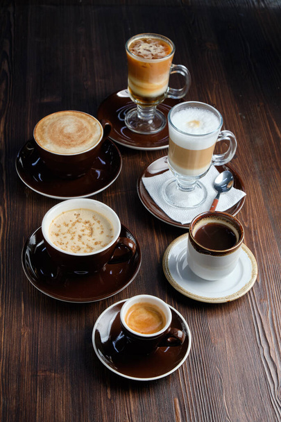 Cappuccino on a brown wooden background. Menu - Valokuva, kuva