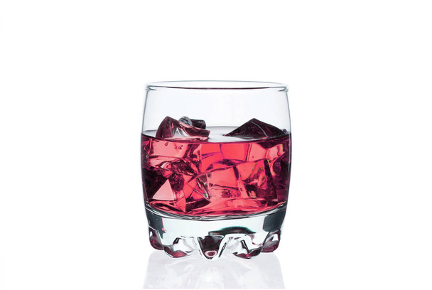 Glass with ice cubes, chilled drink bar, energy drink, colored liquid, isolate white background. - Фото, зображення