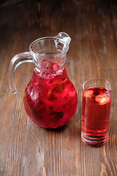 Different soft drinks in transparent jugs on a dark wooden background. menu for catering - Φωτογραφία, εικόνα