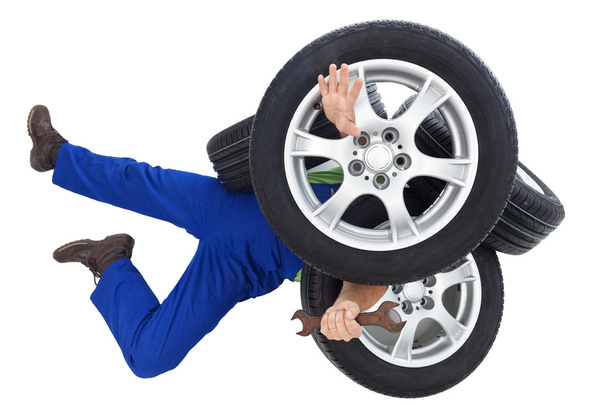 Mechanic covered by car tires - Photo, Image