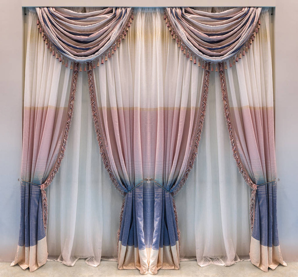 Modern beige cotton curtains with wide blue and pink stripes decorated with classic pelmet - 写真・画像