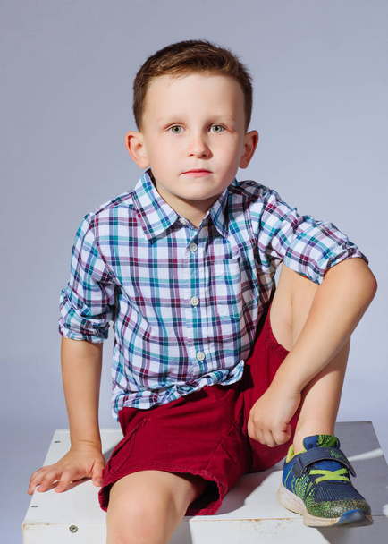 portrait of a little fashionable boy in the studio - Fotó, kép