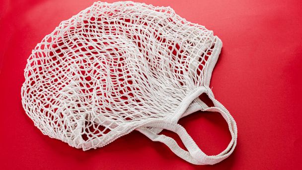 One reusable cotton net bags or mesh bags on coloured background - Foto, Imagem
