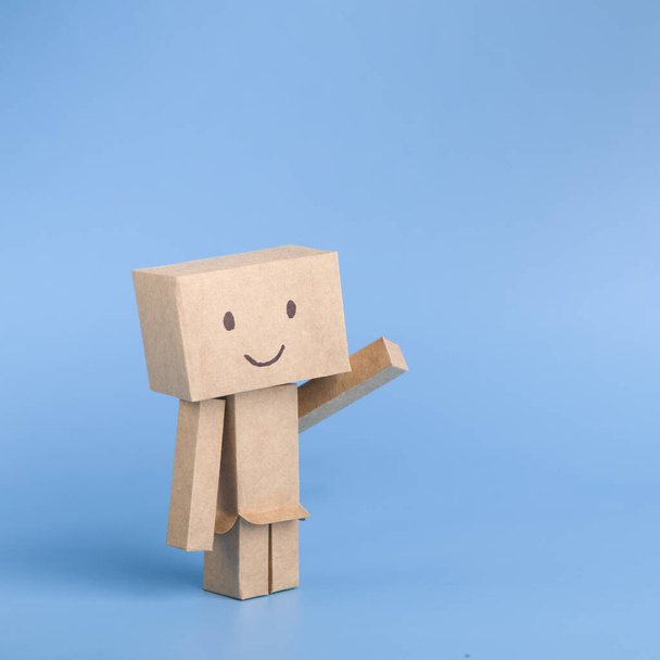Funny toy cardboard robot on blue background - Foto, immagini