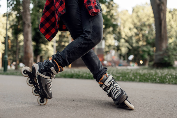 Roller skating, male skater rolling in park. Urban roller-skating, active extreme sport outdoors - Photo, Image