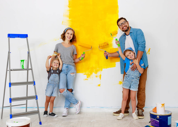 Repair in apartment. Happy family mother, father and children    - Фото, изображение