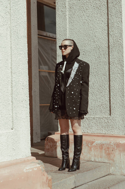 Stylish girl with short hair in a jacket on the street - Fotoğraf, Görsel