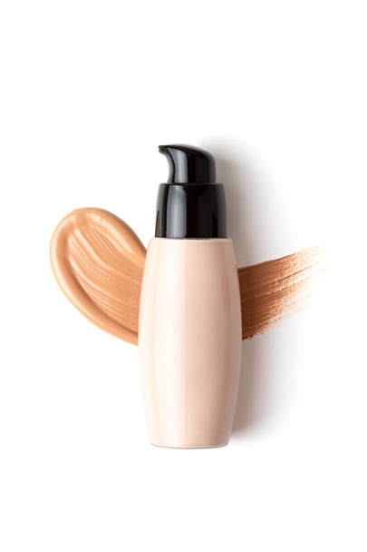 Mockup with make up face foundation bottle and smudged drop of concealer over the white background - Photo, Image