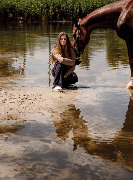 photo wildes Mädchen, das ein Pferd in einem Teich geht - Foto, Bild