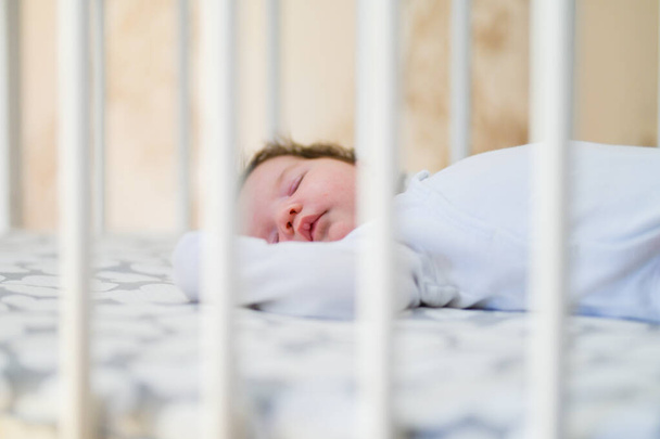first day of the child at home. Newborn baby sleep first days of life. Cute little newborn child sleeping peacefully - Valokuva, kuva