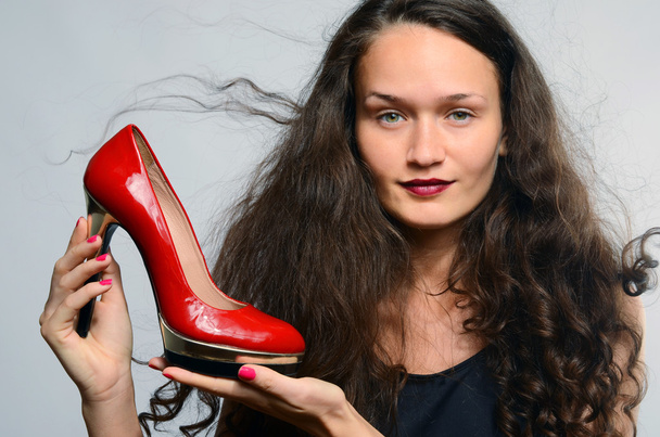Beautiful woman in love with her high heels shoes - 写真・画像