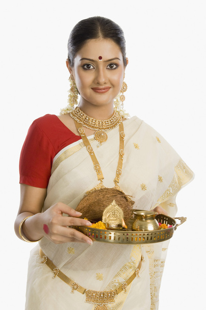 Woman holding a plate of religious offerings - Foto, imagen