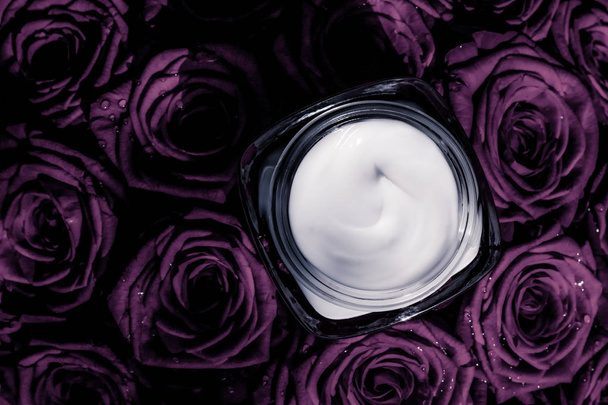 Face cream skin moisturizer on purple roses flowers, luxury skin - Photo, Image