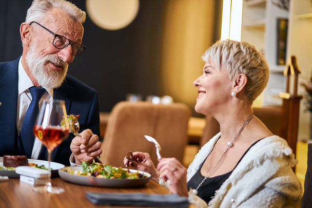 Senior couple in love having dinner in elegant restaurant - Fotoğraf, Görsel