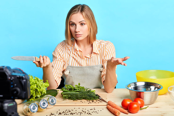 Cute female chef telling cooking hacks to followers while online master class - Foto, Bild