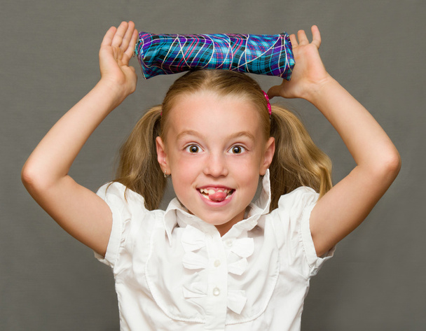 Cheerful schoolgirl with pencil case.School concept - Photo, Image