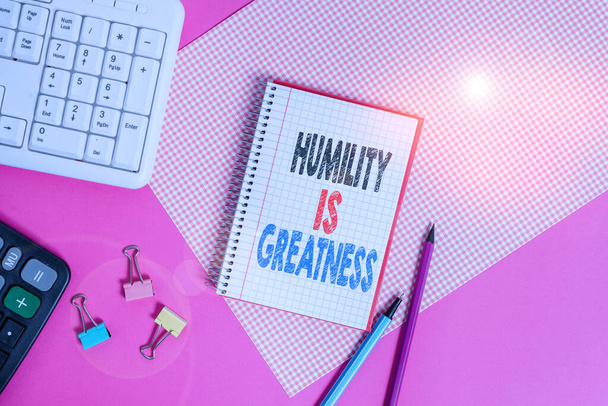 Text sign showing Humility Is Greatness. Conceptual photo being Humble is a Virtue not to Feel overly Superior Writing equipments and computer stuffs placed above colored plain table. - Photo, Image