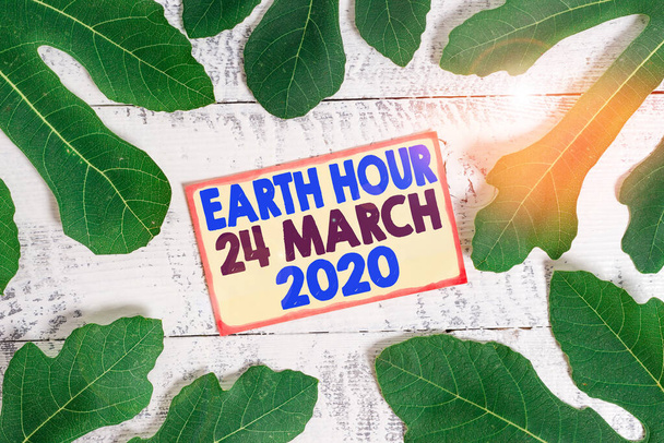 Znak tekstowy pokazujący godzinę Ziemi 24 marca 2020. Fotografia konceptualna Świętuj zrównoważony rozwój Zapisz światła planety. - Zdjęcie, obraz