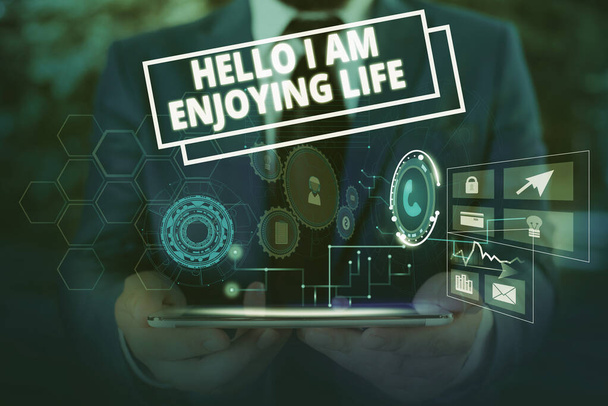 Conceptual hand writing showing Hello I Am Enjoying Life. Business photo showcasing Happy relaxed lifestyle Enjoy simple things Male wear formal suit presenting presentation smart device. - Photo, Image