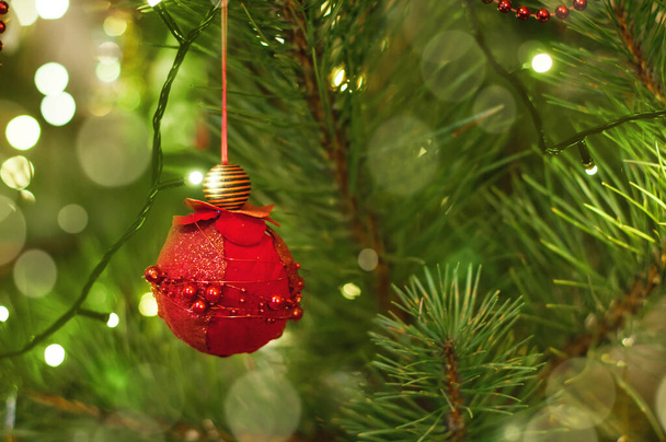 Red hand made christmas ball hanging on a christmas tree - Zdjęcie, obraz