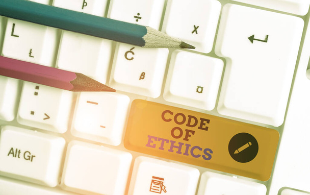 Conceptual hand writing showing Code Of Ethics. Business photo showcasing basic guide for professional conduct and imposes duties White pc keyboard with note paper above the white background. - Photo, Image