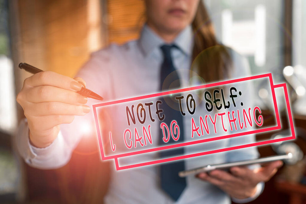 Text sign showing Note To Self I Can Do Anything. Conceptual photo Motivation for doing something confidence Blurred woman in the background pointing with finger in empty space. - Photo, Image