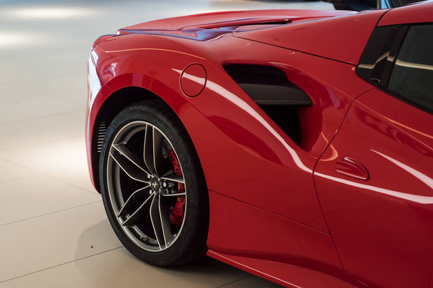 Closeup of red Ferrari front in Ferrari retailer showroom  - Fotó, kép