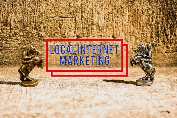 Text sign showing Local Internet Marketing. Conceptual photo use Search Engines for Reviews and Business List Two Bronze Chess Pieces Knights Facing Each Other in Focus and Defocused. - Photo, Image