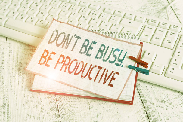 Word writing text Don T Be Busy Be Productive. Business concept for Work efficiently Organize your schedule time notebook paper reminder clothespin pinned sheet white keyboard light wooden. - Foto, imagen