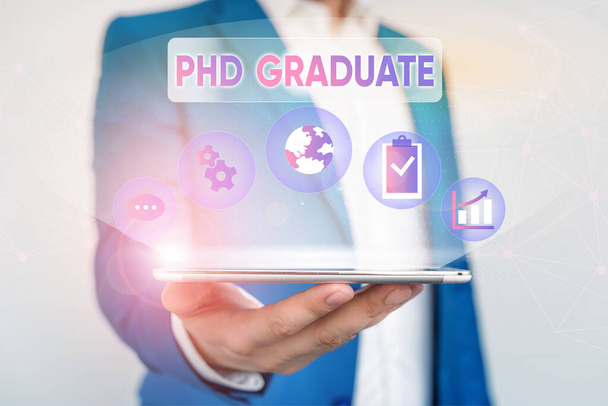 Writing note showing Phd Graduate. Business photo showcasing highest university degree that is conferred after a course Male human wear formal suit presenting using smart device. - Photo, Image