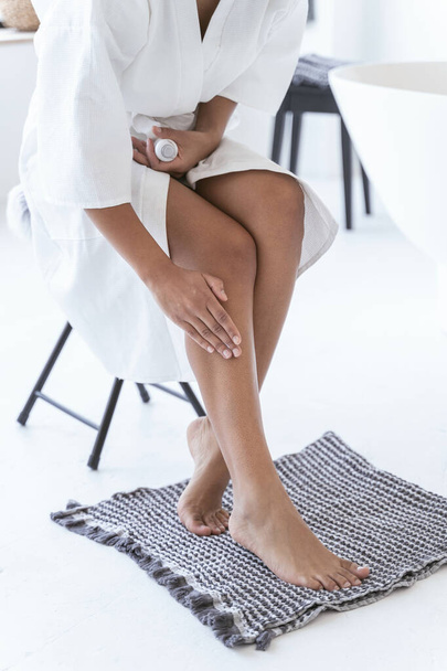 Woman massaging her legs with special oil - Φωτογραφία, εικόνα