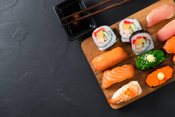 close up of sashimi sushi set with chopsticks  - Фото, зображення