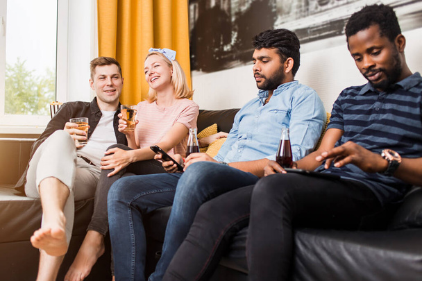 Group of friends watching television at home together - Photo, image
