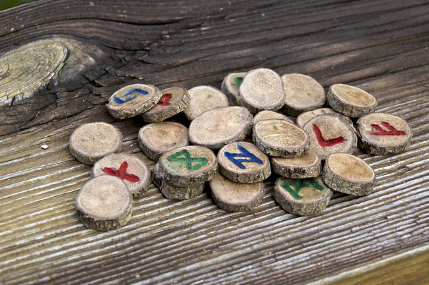 collection of wooden runes on weathered board - Photo, Image