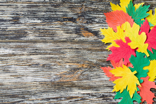 Artesanía de papel, hojas de otoño rojas y amarillas. Vista superior sobre plano sobre fondo de madera vintage
. - Foto, Imagen