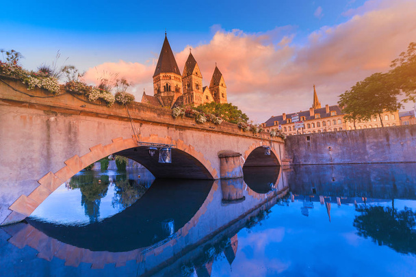 Кольоровий вид на стародавню церкву Нойфа на березі річки Мозель у Меці, Франція, під час сходу сонця. Туристичні пам'ятки та концепції міського життя - Фото, зображення
