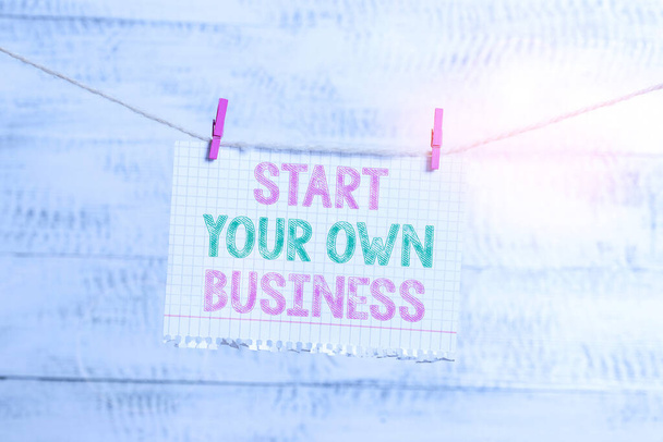 Writing note showing Start Your Own Business. Business photo showcasing Entrepreneurial Venture a Startup Enter into Trade Clothesline clothespin rectangle shaped paper reminder white wood desk. - Photo, Image
