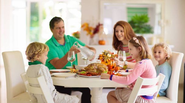 Family with kids at Thanksgiving dinner. Turkey. - Photo, Image