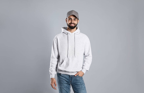 Portrait of young man in sweater on grey background. Mock up for design - Foto, immagini