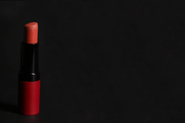Red matt lipstick isolated on black background with reflection. New open velvet satin airy lip stick with cap. - Foto, Imagem
