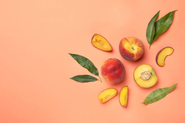 Flat lay composition with sweet juicy peaches and space for text on orange background - Φωτογραφία, εικόνα