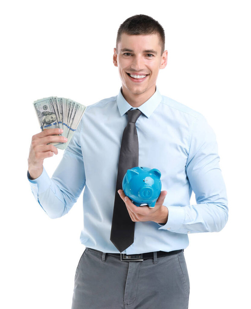 Handsome businessman with dollars and piggy bank on white background - Foto, immagini