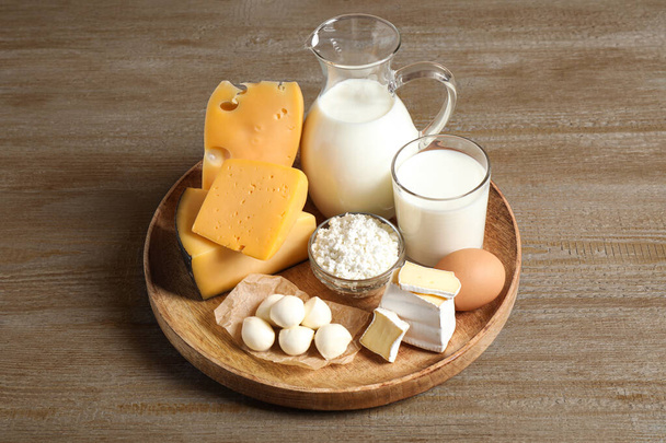 Different delicious dairy products on wooden table - Foto, Imagem