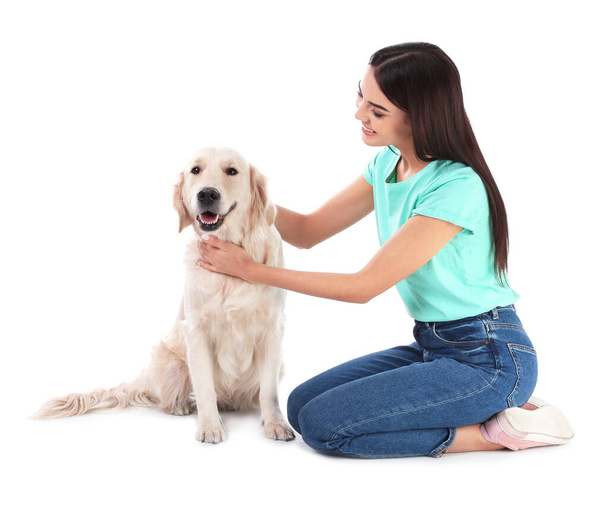 Young woman and her Golden Retriever dog on white background - Фото, изображение
