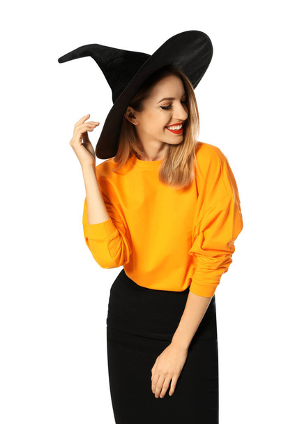 Beautiful young woman wearing witch costume for Halloween party on white background - Valokuva, kuva