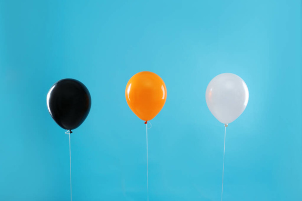 Colorful balloons on blue background. Halloween party - Foto, Imagem