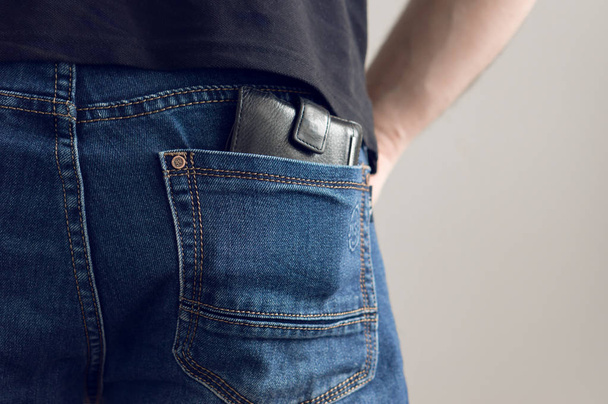 Purse in jeans pocket - Фото, изображение