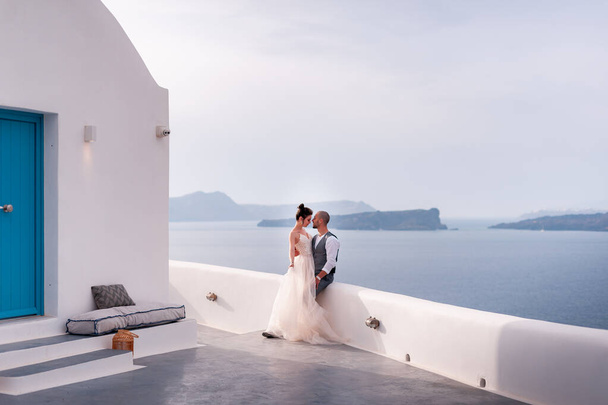 beautiful bride and groom in their summer wedding day on greek island Santorini - Valokuva, kuva